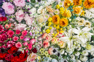 Floral background. Lot of  Decoration artificial flowers in colorful composition