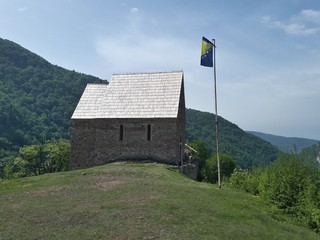 Old medieval capel with Bosnian flag