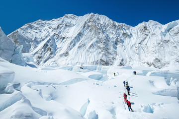 Goup of climbers reaching the Everest summit in Nepal. Team work concept.