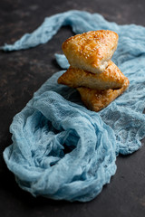 Asian cuisine. Homemade samsa with chicken, sesame and greens on a dark background. Top view side View. Space for text