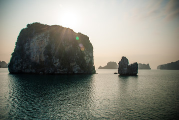 Halong Bay, rock formation with sun rays visible from behind. Vietnam