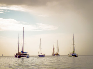 a collection of yachts on the water varying in size