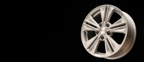 new aluminum alloy wheel, silver color on a black background. copy space