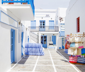 Picturesque scenic narrow streets with traditional whitewashed houses with blue doors windows of...