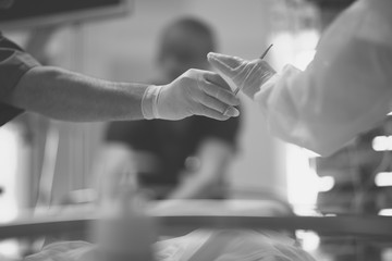 The hands of the dentist and his assistant with the tool during medical manipulations