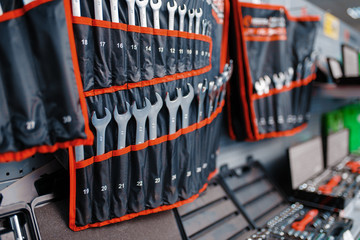 Showcase with wrenches kits in tool store closeup