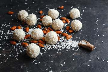 Homemade sweets, white Raffaello balls with almonds and condensed milk inside and covered with coconut shavings, traditional Christmas sweets