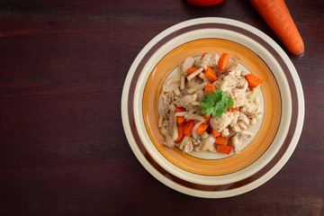 Roasted chicken with carrots and mushroom on wooden background, Healthy plate concept.