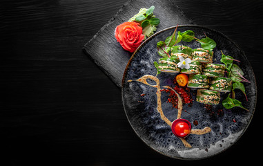 sushi roll in plate on black wooden table background