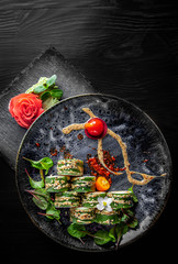 sushi roll in plate on black wooden table background