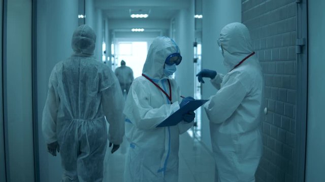 Two doctors discuss their work in clinic.