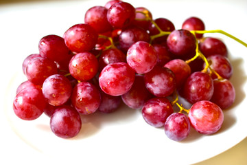 Bunch of red and large grapes on a white background