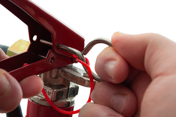 Fire prevention equipment concept with closeup on firefighter hand pulling the pin on a red fire...