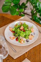 light healthy salad of fresh vegetables and shrimp. Photo in the interior