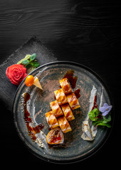 sushi roll in plate on black wooden table background