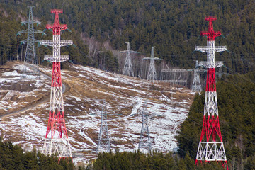 in the forest on the field there are towers with power lines, (high voltage, voltage wires) a view...