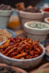 Indian spices collection, dried red hot chili peppers and another spices in clay bowls