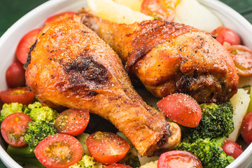 Grilled chicken leg with boiled potatoes and vegetable