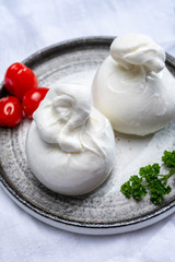Cheese collection, fresh soft white burrata cheese ball made from mozzarella and cream from Apulia, Italy