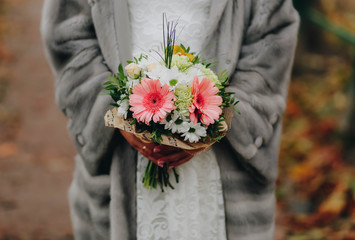 Wedding bouquet, a bouquet of flowers in the hands of the bride close-up