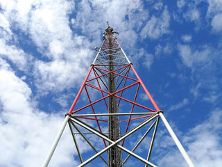 GSM repeater tower in front of blue cloudy sky