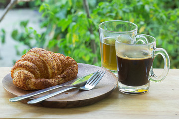 Thai Black Coffee and hot Tea with croissant bread on  Wooden Bar