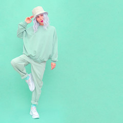 Hipster teen girl posing in studio. Urban style. Hip-hop. Fresh fashion mint monochrome aesthetic...