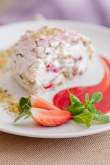 beautiful tasty green vegan dessert pistachio strawberry rolls on a wooden table in the interior.