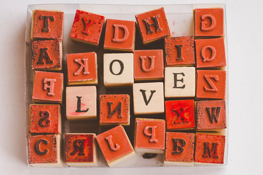 Directly Above Shot Of Red Alphabet Toy Blocks On Table