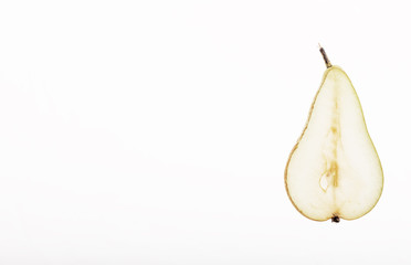 Isolated half of a green colorful conference pear on a white background with copyspace. 