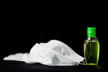 Sanitizer gel or antibacterial soap and face mask for coronavirus preventive measure, top view