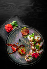 sushi roll in plate on black wooden table background