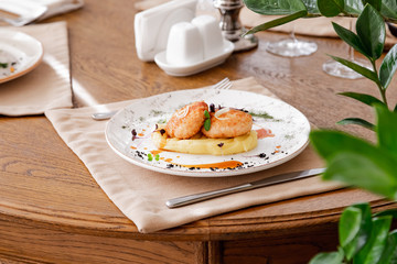 mashed potatoes with cutlet, on a beautiful white plate. The dish is decorated with micro-greens....