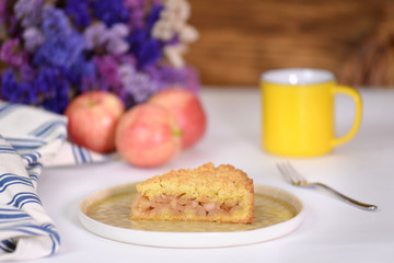 A piece of apple pie on white backstage.