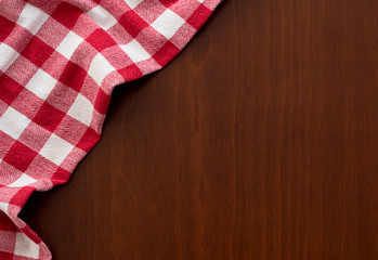 Fototapeta na wymiar red tablecloth on wooden background
