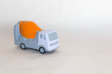 layout of concrete truck mixer on rough white-grey background. Free copy space. Delivery of ready...
