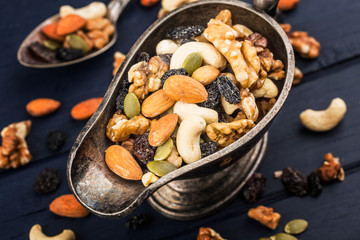 Mixed nuts on wooden board background