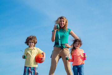 Healthy sport family lifestyle. Happy family Mother and child standing on sky background. Mother, daughter and son miking sport.
