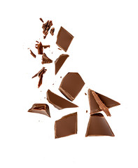 Chocolate pieces and shavings isolated on white background. Chunks of dark chocolate falling close...