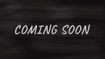 Fototapeta premium Coming soon concept on black blackboard. Handwriting typography on chalkboard