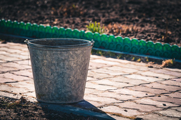 Naklejka premium Iron bucket for cleaning garbage from the garden area.
