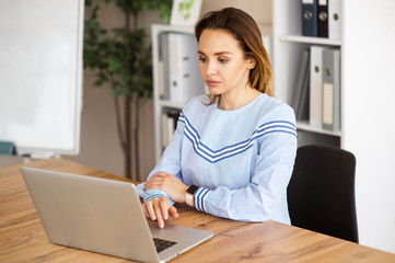 Portrait of business woman working with laptop in office