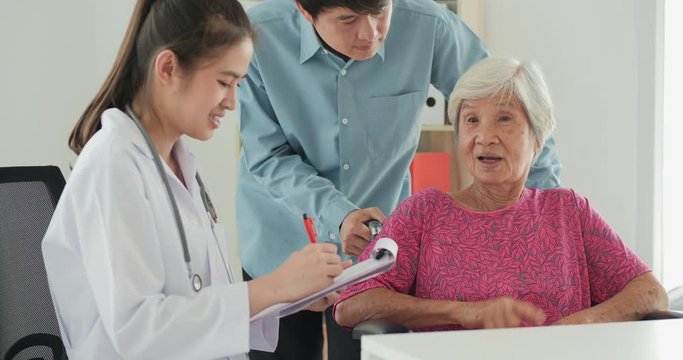 Friendly mature general practitioner communicating with pleasant 80s female patient. Smiling trustful middle aged doctor giving psychological help to elder woman. Health care and medical concept.