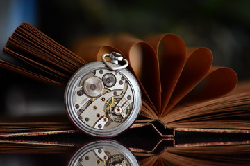 old pocket watch and book 