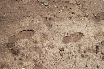 Footprint of shoes on the soil after rain.