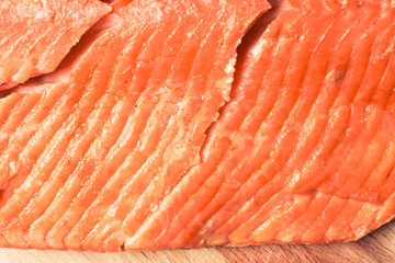 Smoked coho red fish fillet on cutting board.