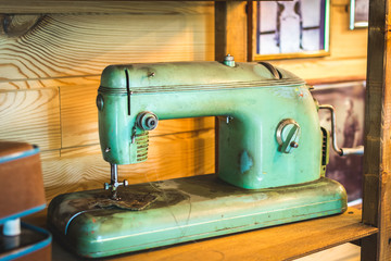 Sewing machine for embroidery and repair of clothes and linen on the table.
