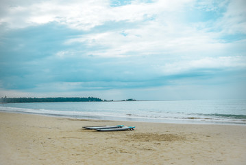 Surfboards on sandy beach, turqouise water and sky, Thailand, Asia