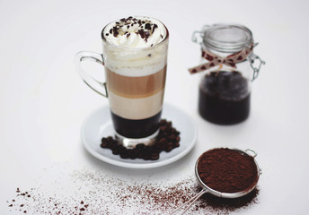 Layered latte coffee with chocolate, cocoa and plum jam