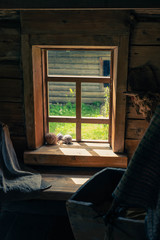 The morning sun shines through an old, rural window